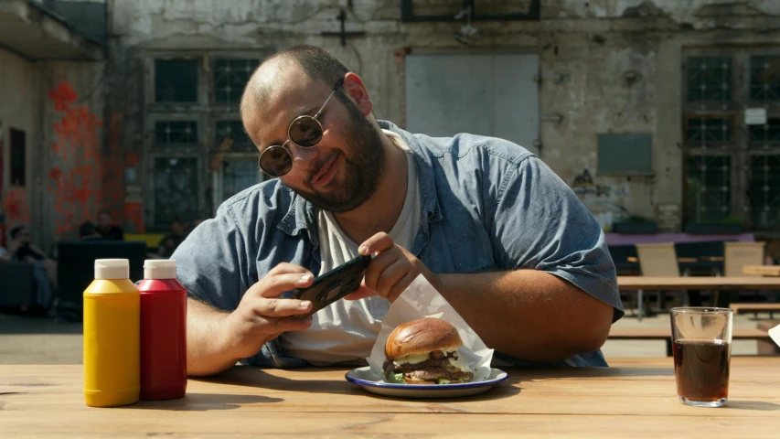 a man taking a po of food with his phone