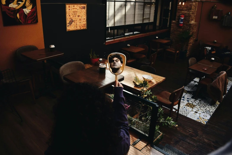 a person at a restaurant looking at his camera