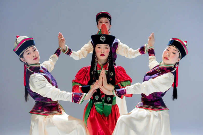 three women in costume are standing in the air