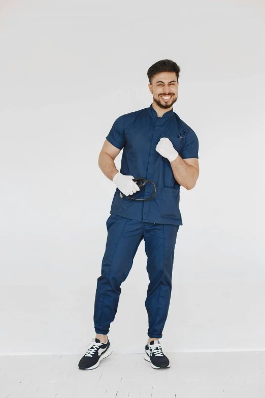 a man posing for a po wearing a pair of work gloves