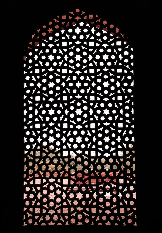 an intricate window with a pattern on the front