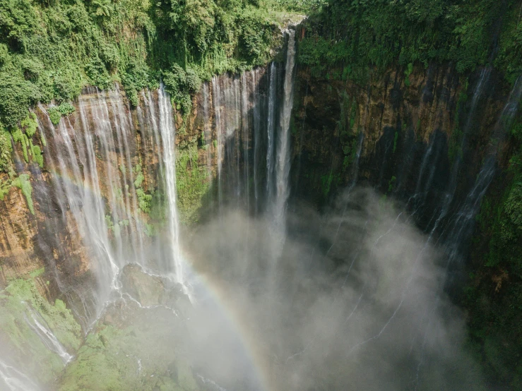 the water pours from a high waterfall