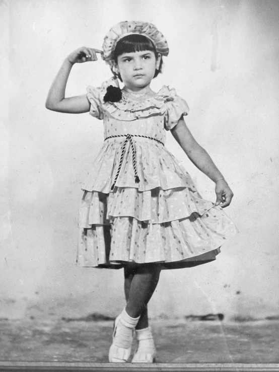 an old po of a little girl posing for the camera