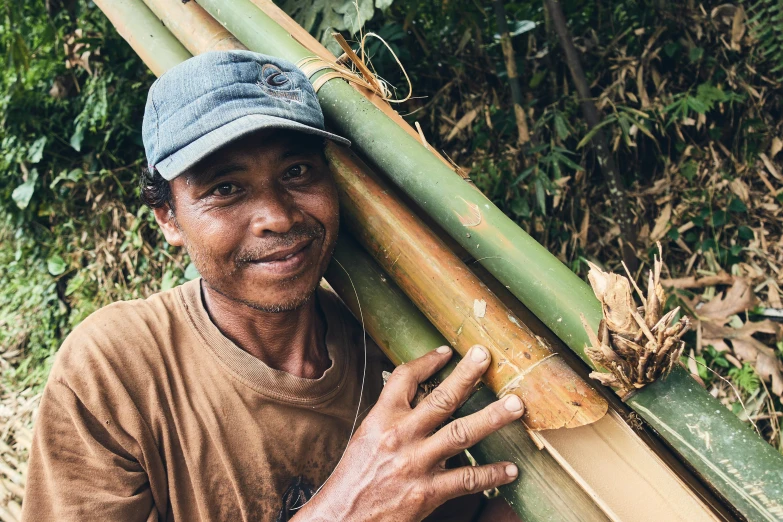 a person standing with a bamboo pole on his back