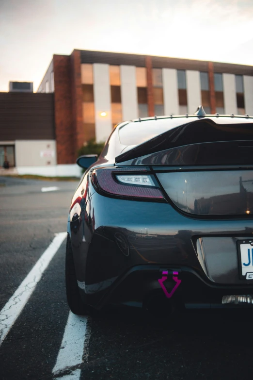 a car is parked near a building in a parking lot