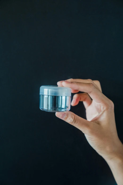 a person's hands holding onto an empty container