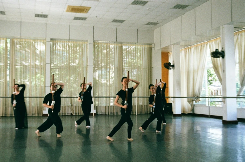 a group of people dancing in a dance studio