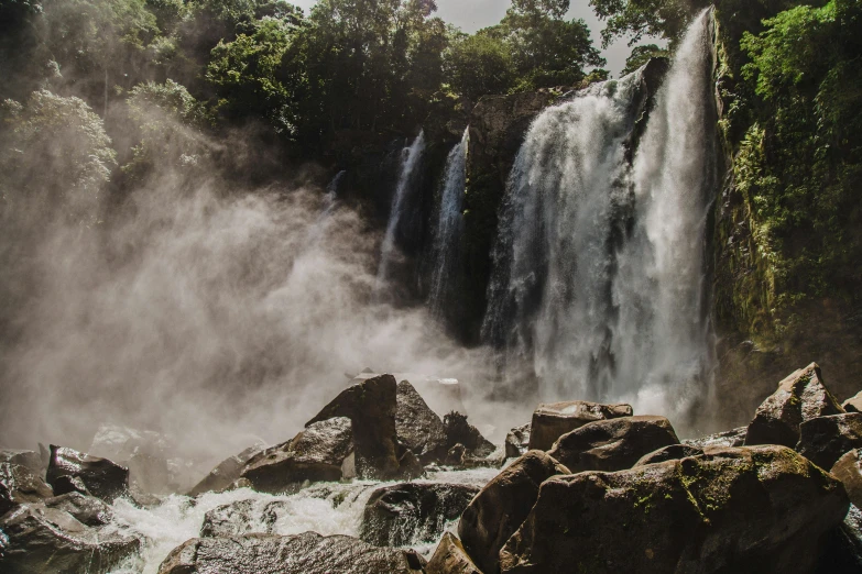 an image of waterfall with smoke and water