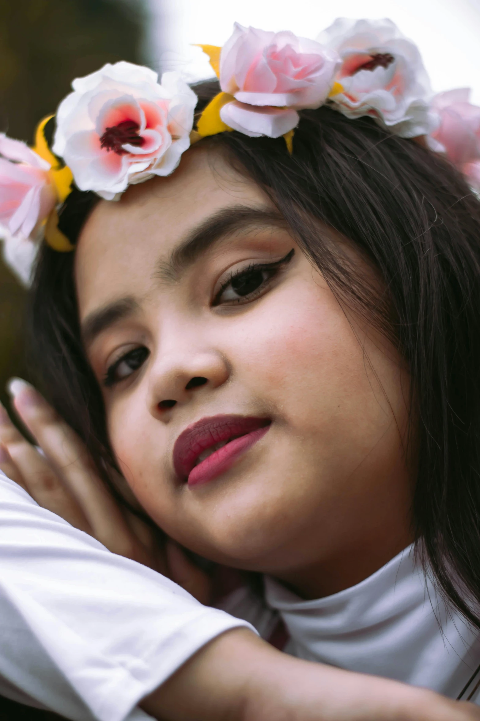 a girl wearing a flowered wreath on her head