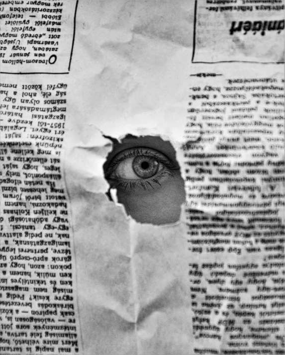 the view through paper shows a hole in an eye