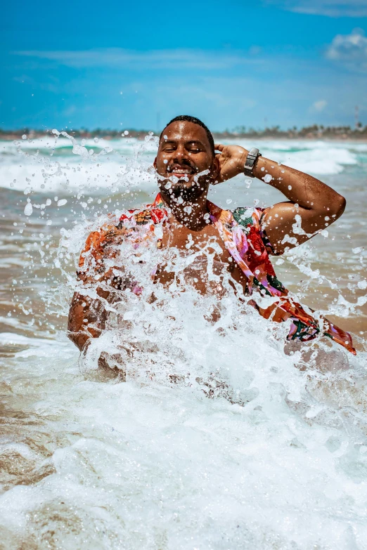 a man in colorful swimsuit standing in the ocean