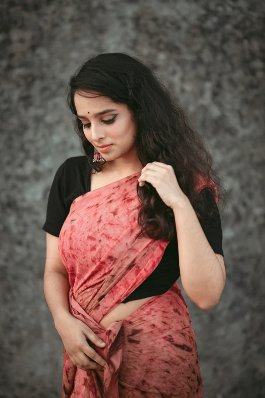 woman in sari holding open shirt with hand