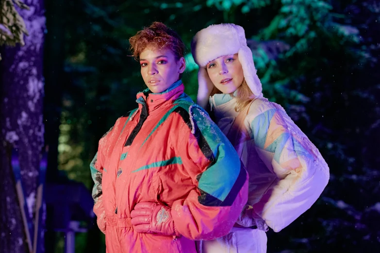 two girls standing side by side on the runway