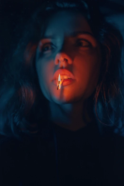 a woman in dark lighting with her mouth open