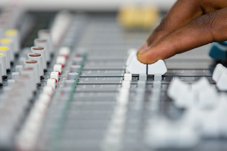 a close up of a control board with a person pressing ons