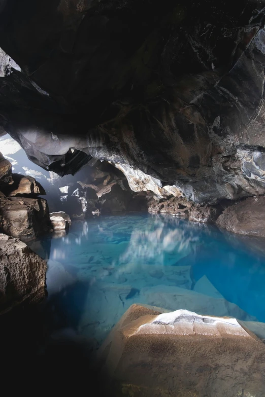 a pool of water in a rocky outcropping