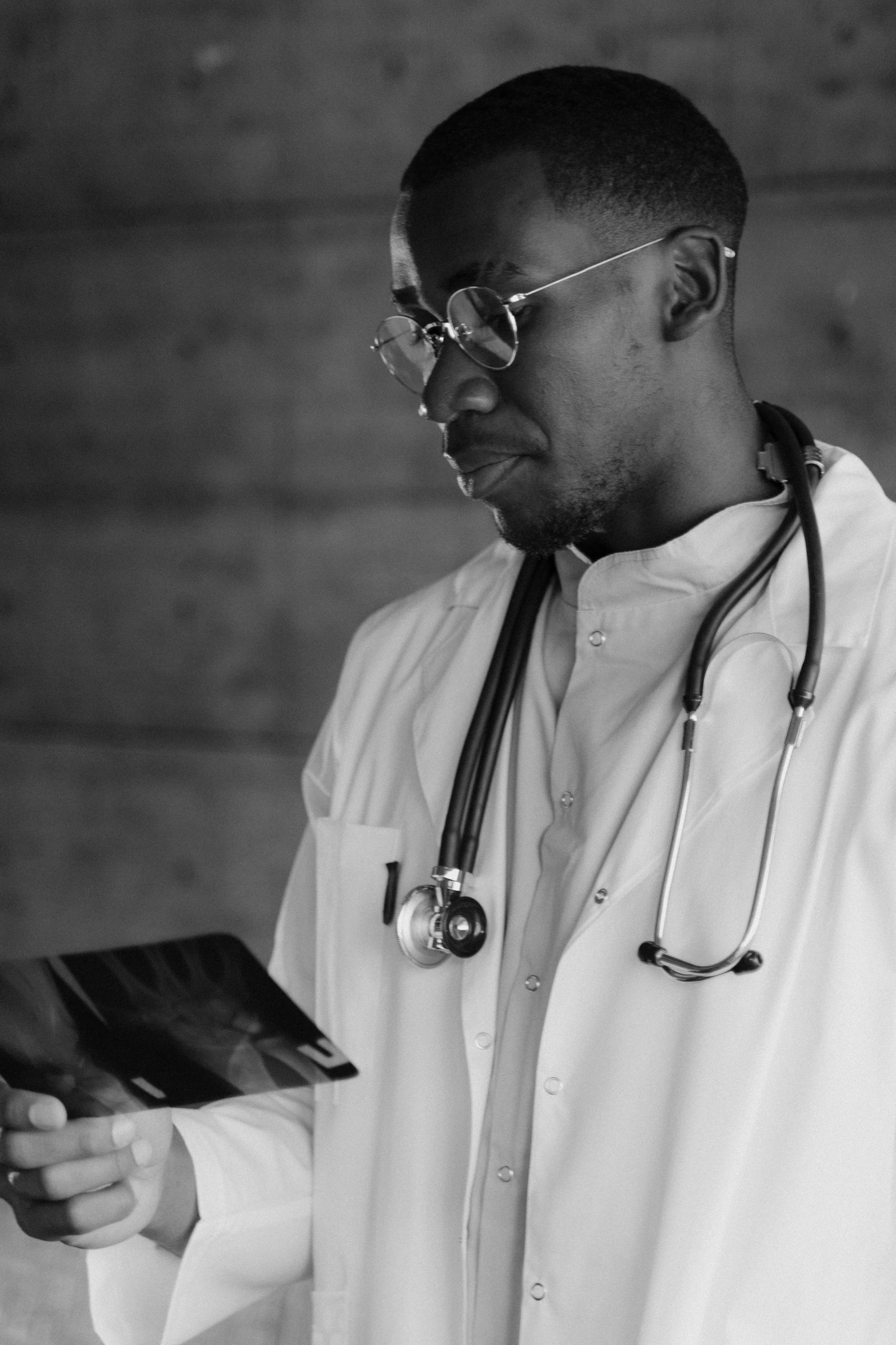 man in shirt and glasses with stethoscope on his neck