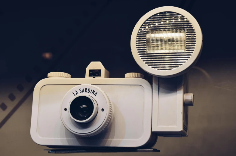 a white camera that is attached to a light