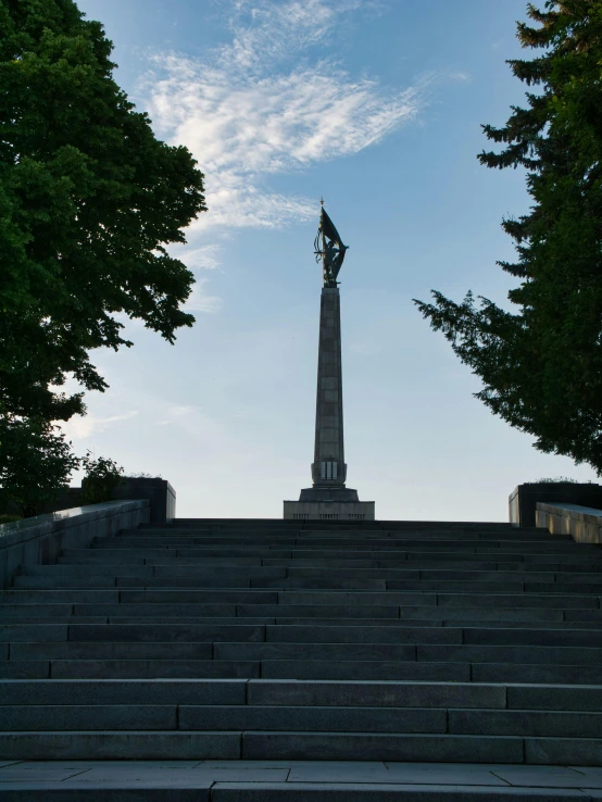 a large statue sitting on the top of some stairs