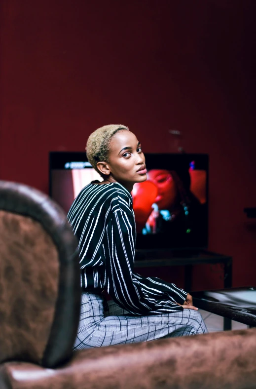 a woman is sitting in front of a tv