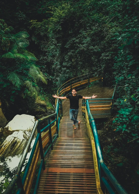 a man standing on the end of a bridge