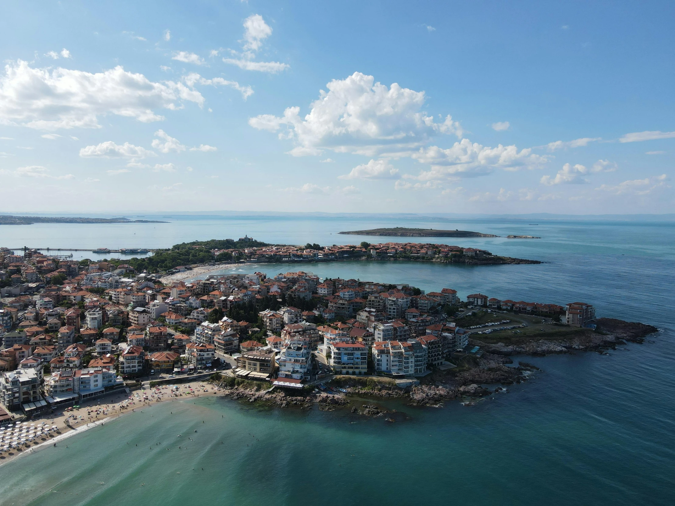 the aerial view shows several buildings near the ocean