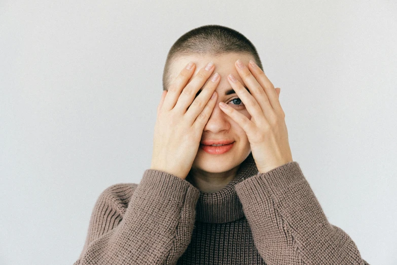 a person holding their hands up to their eyes