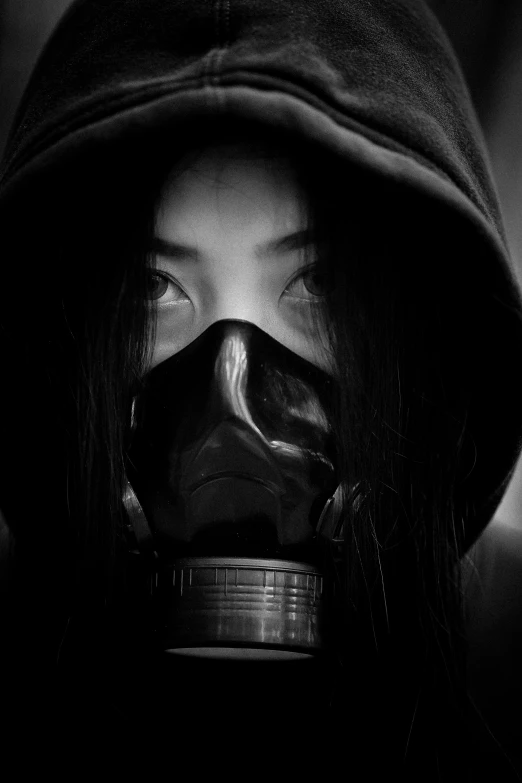 woman with hood up and skull mask over her face