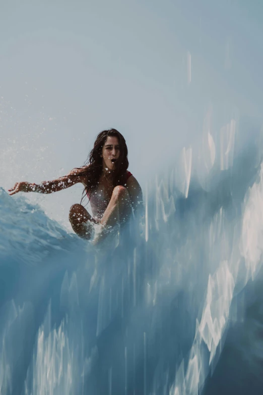 a surfer is riding an ocean wave on her surfboard