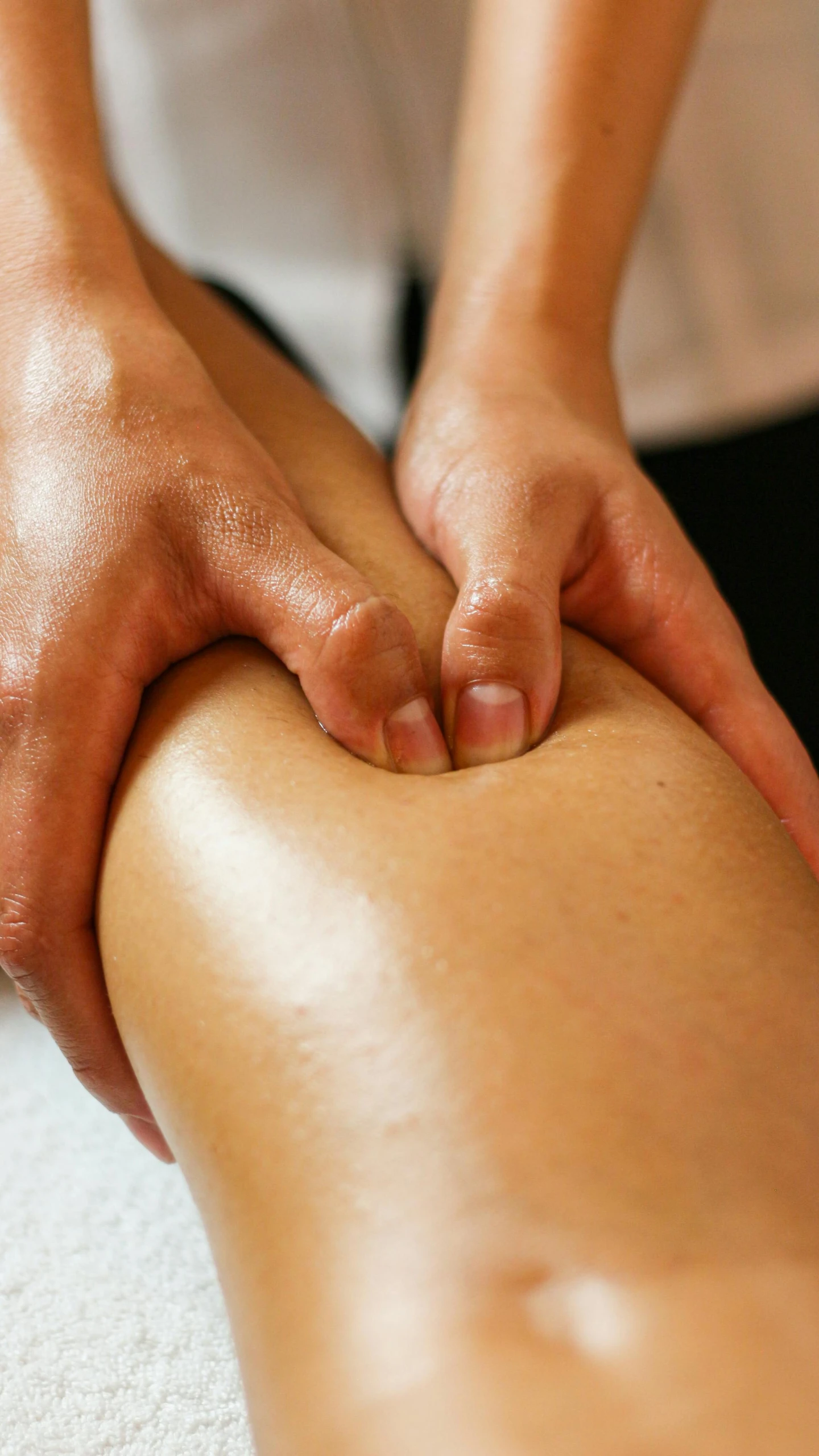 a woman's back being massaged by her friend