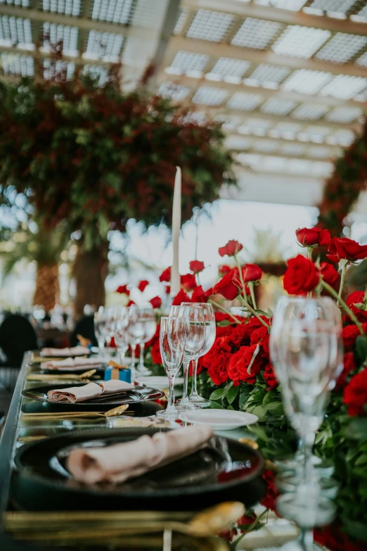 a long table with flowers on it and place setting