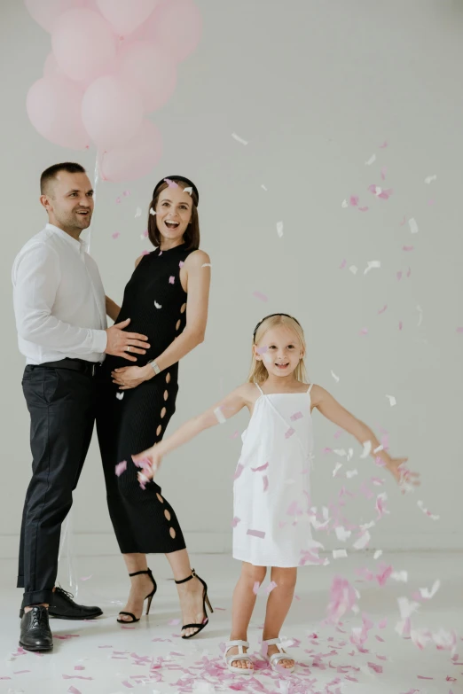 a family on their birthday taking pos with balloons