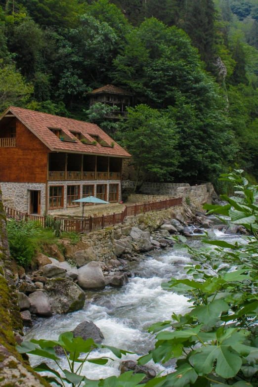 the house is in the woods near the stream