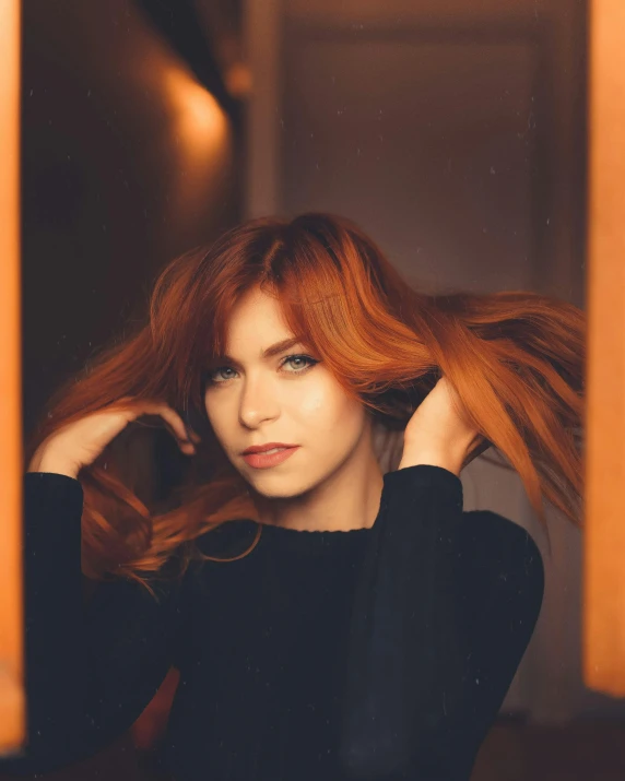 a young woman is posing in a room with red hair