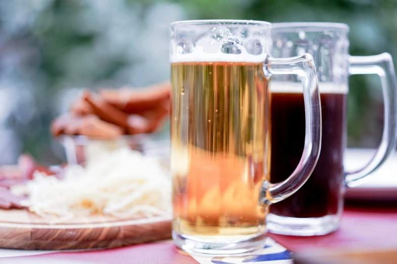 a close up of a beverage mug next to a plate with food