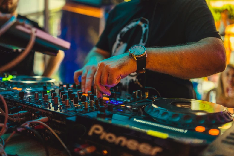 a man mixing music on the sound mixer