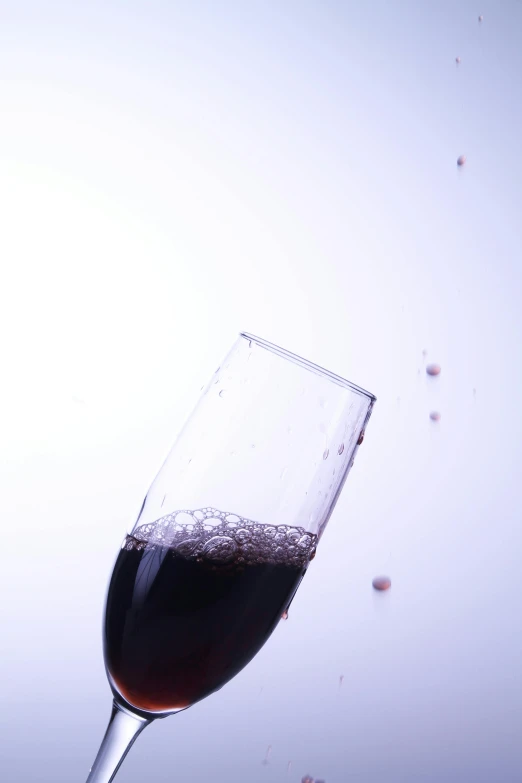 a half full glass of wine on a table