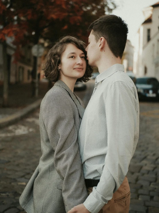 a couple poses for their wedding po in a quiet alleyway