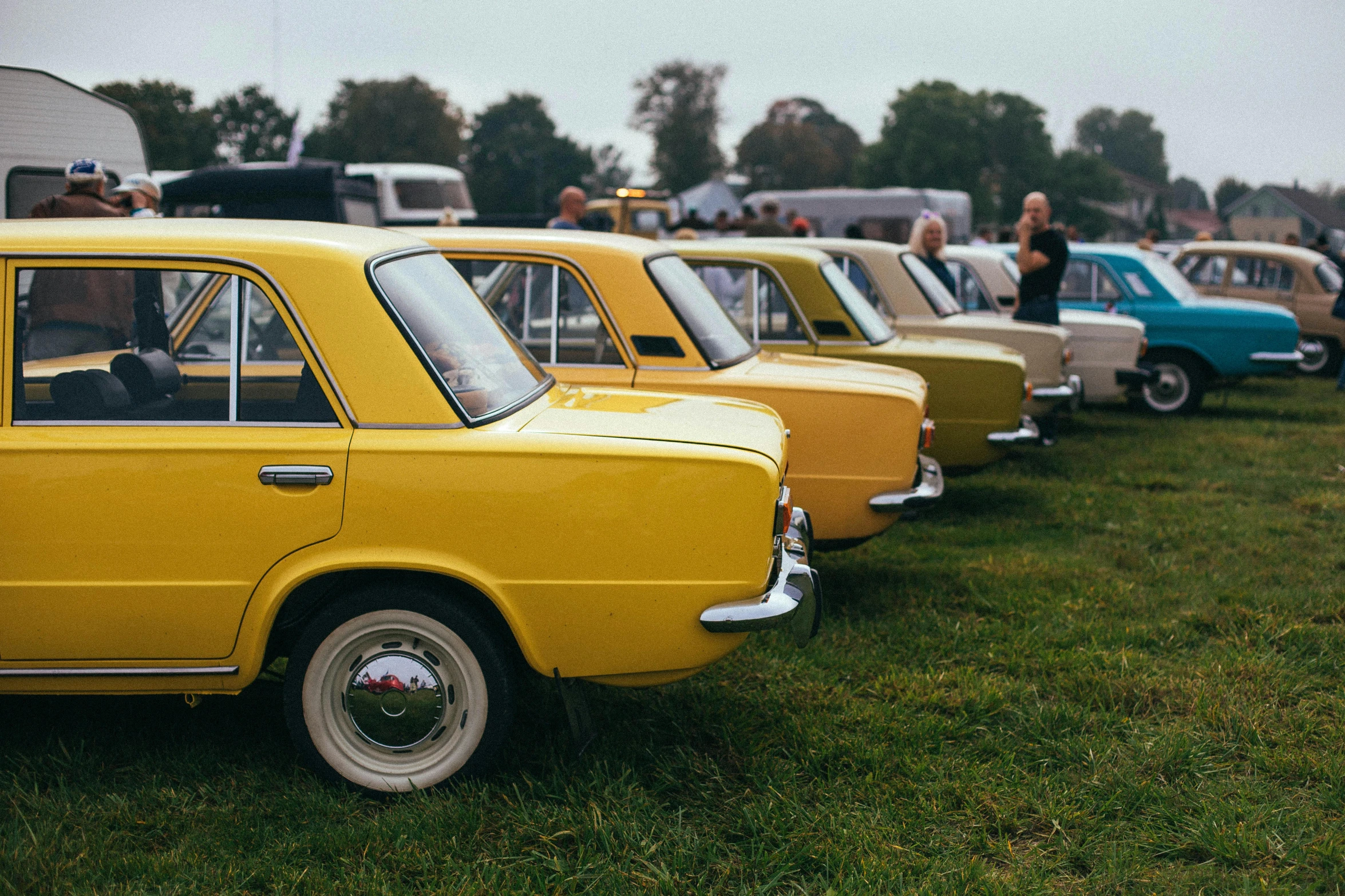 a row of classic cars are parked next to each other