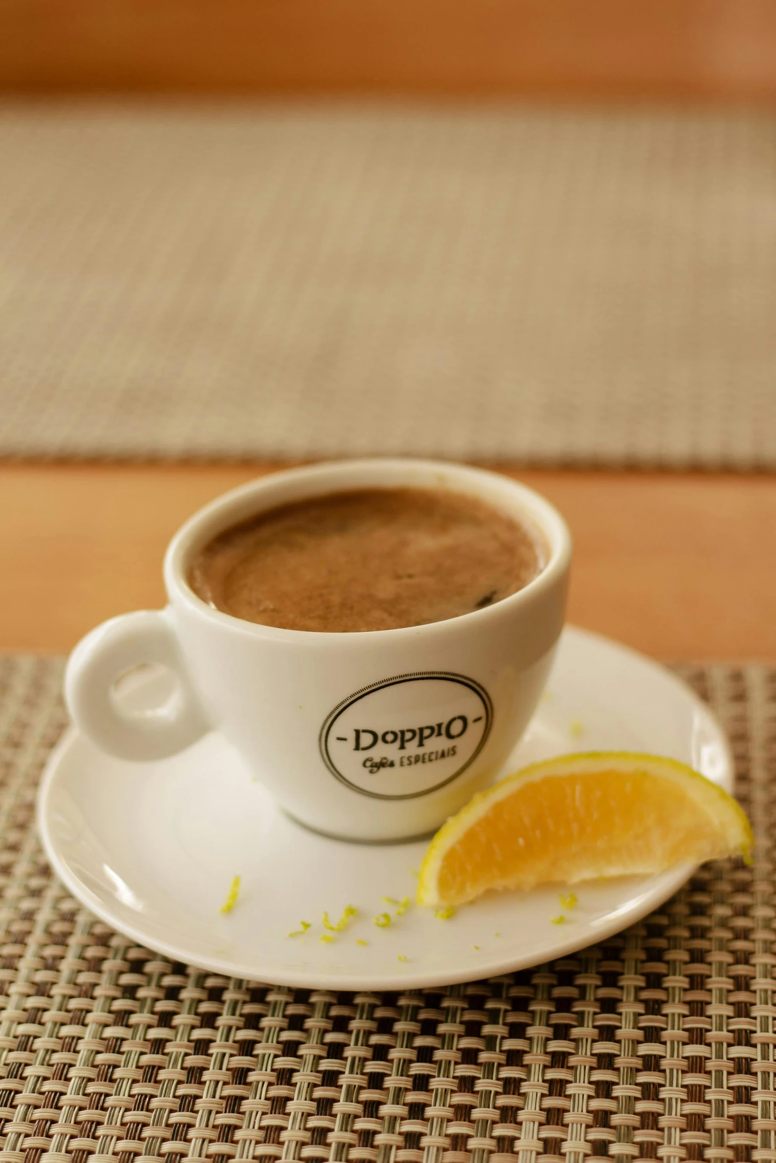 a close up of a cup of coffee on a saucer