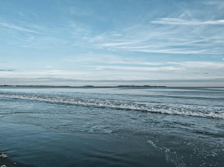 someone is standing in the ocean and looking out at soing