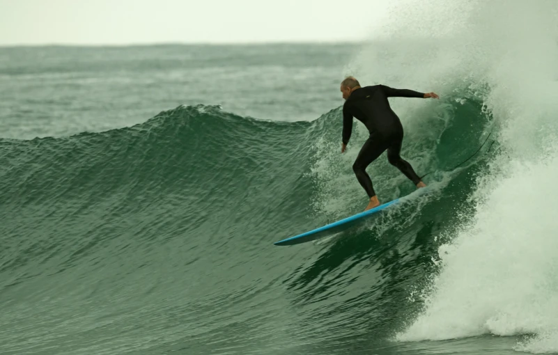 a man riding a wave on top of a surfboard