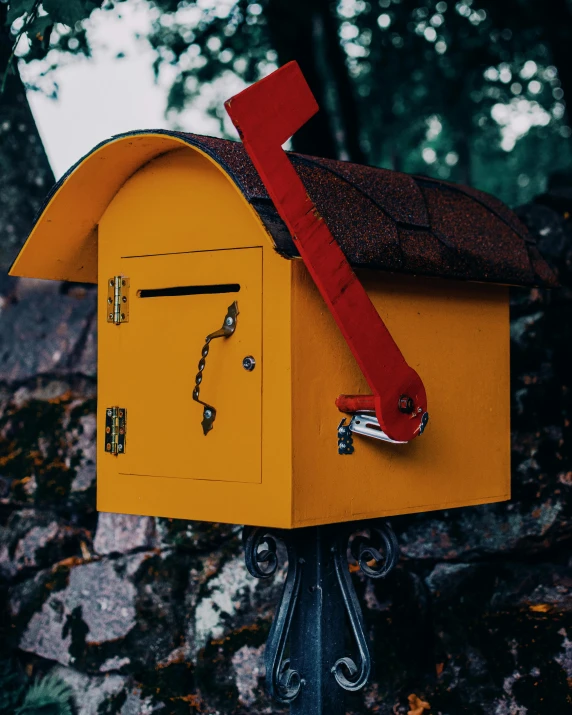 there is an orange mailbox with a red arrow