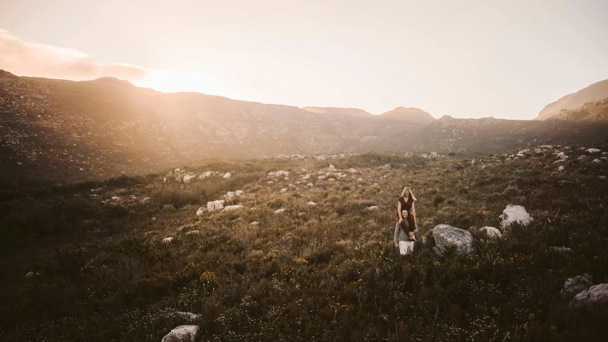 there is a woman walking in the mountains