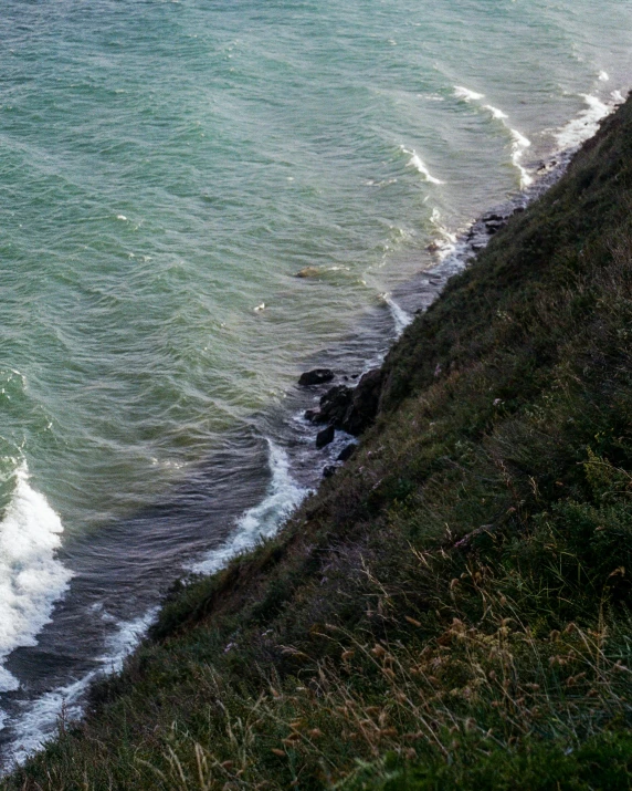 a hill above the ocean and the sea water