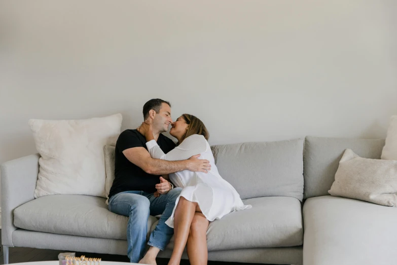 a young couple sitting on a couch in the living room together