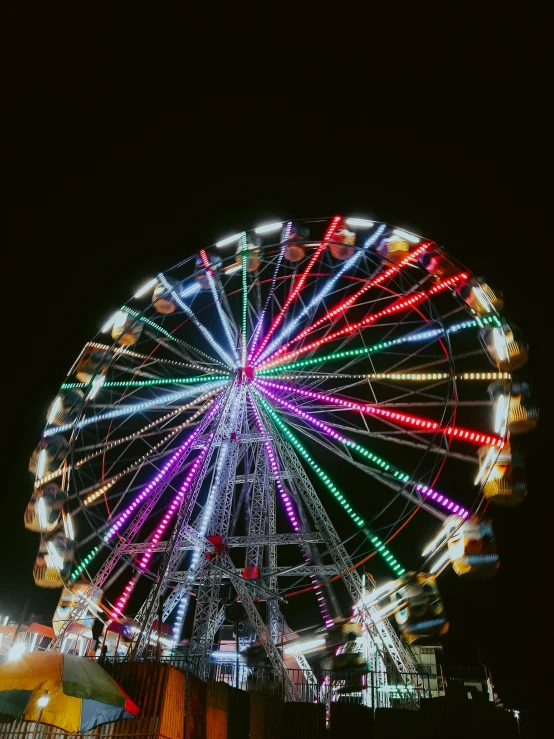 the ferris wheel is lit up on the night