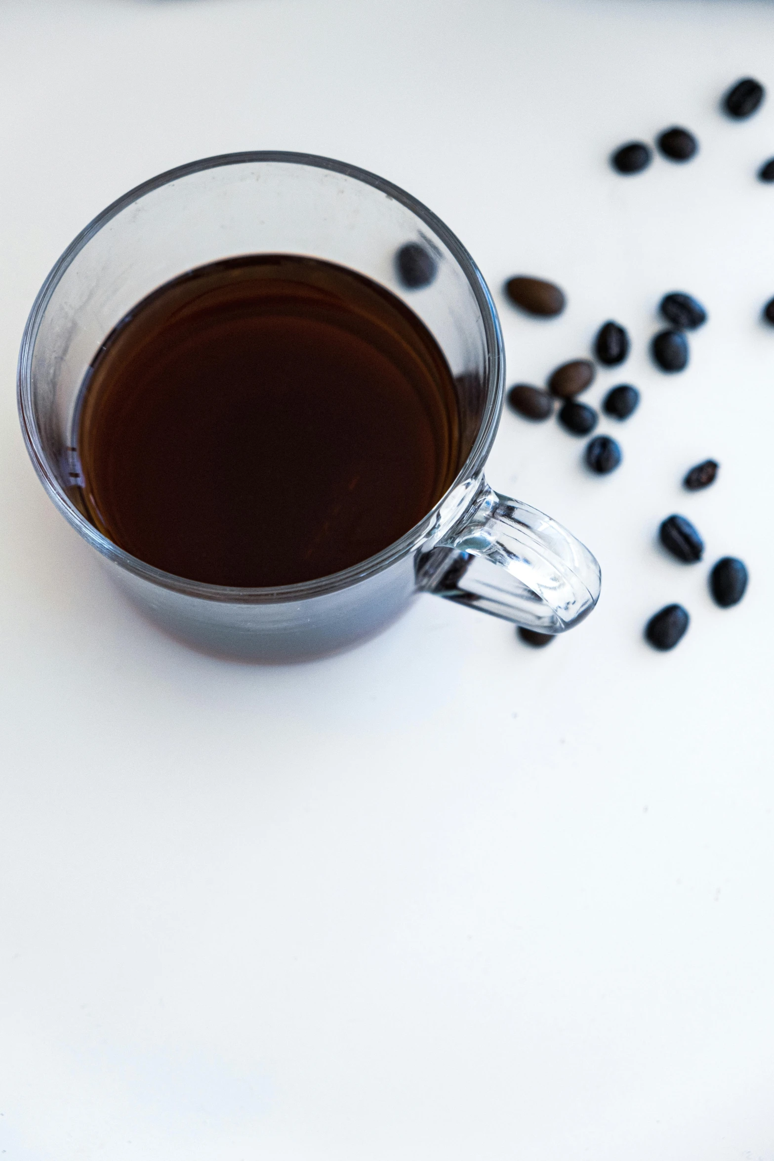 a glass mug with some black beans in it