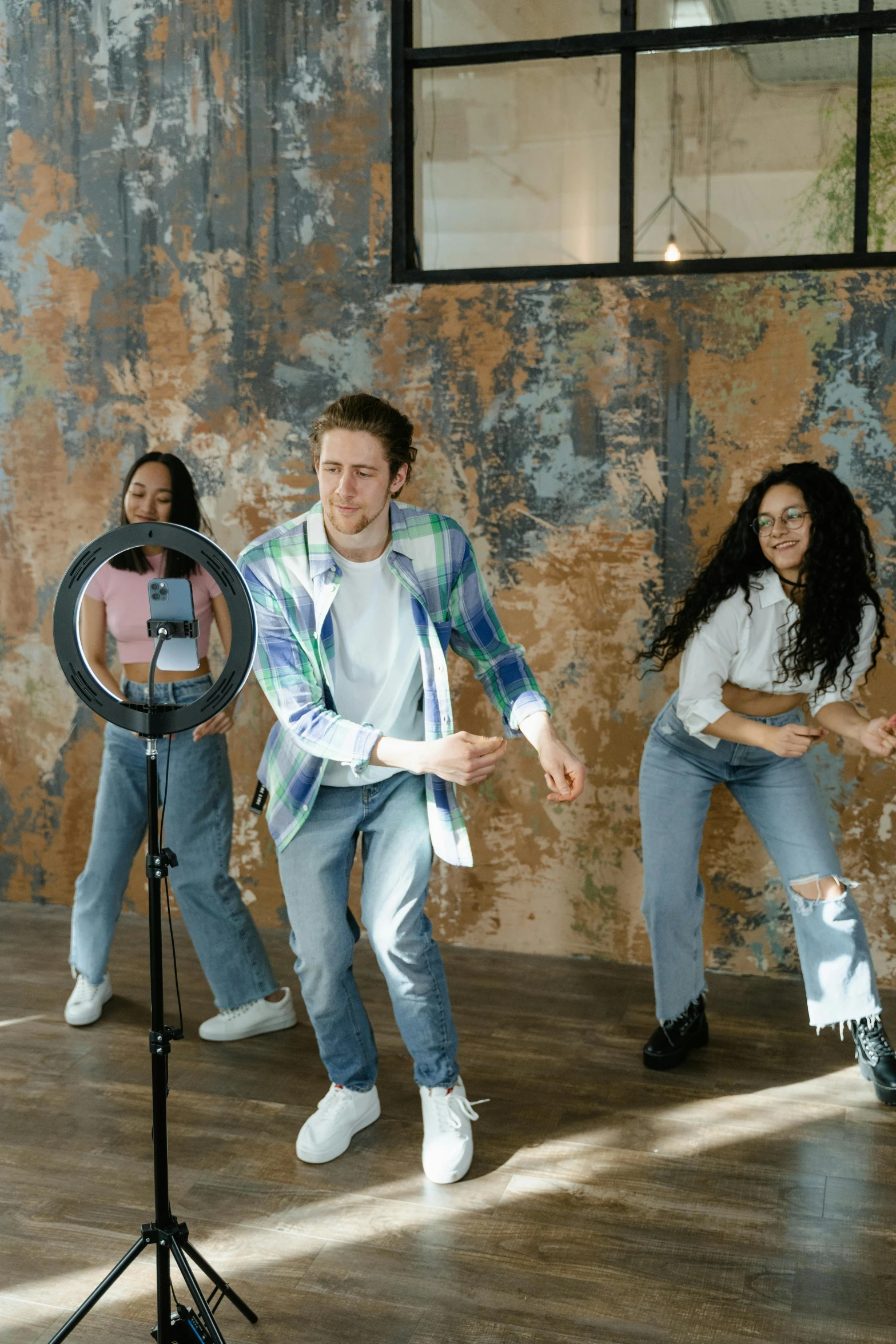 young people playing a sport in an empty room