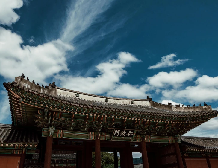 an asian temple is featured against the blue sky